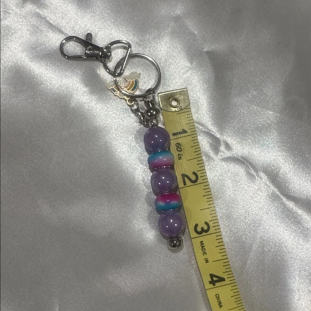 Addie’s Bag Charms purple and rainbow with rainbow charm